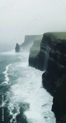 Misty cliffs at the edge of the atlantic ocean on a foggy day in ireland