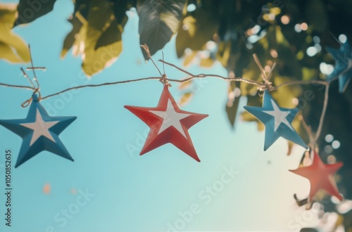 Colorful stars hanging against a clear sky while sunlight filters through the...