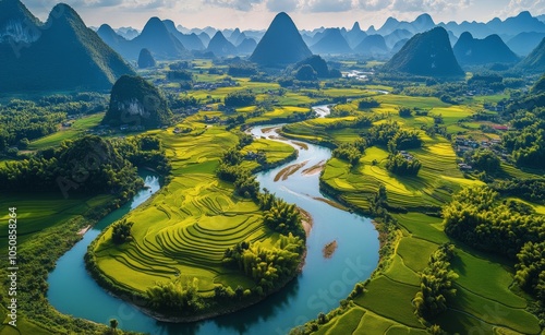 Stunning aerial view of winding river through lush green rice terraces in Gua...