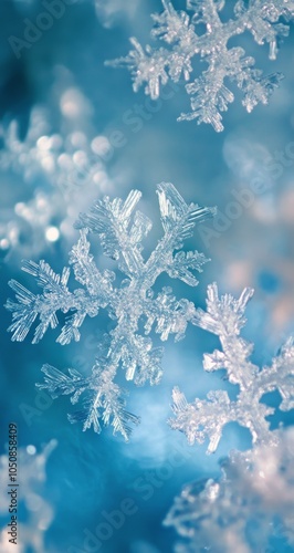 Delicate snowflake resting on glistening winter surface with blurred blue bac...