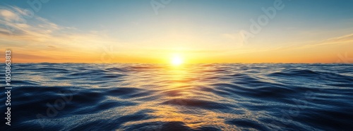 Golden sunset over calm ocean waves creates a serene atmosphere at twilight