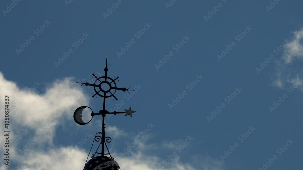 Weather vane on a church dome, spinning on a windy afternoon, real time video Weather vane on a church dome, spinning on a windy afternoon, real time video
