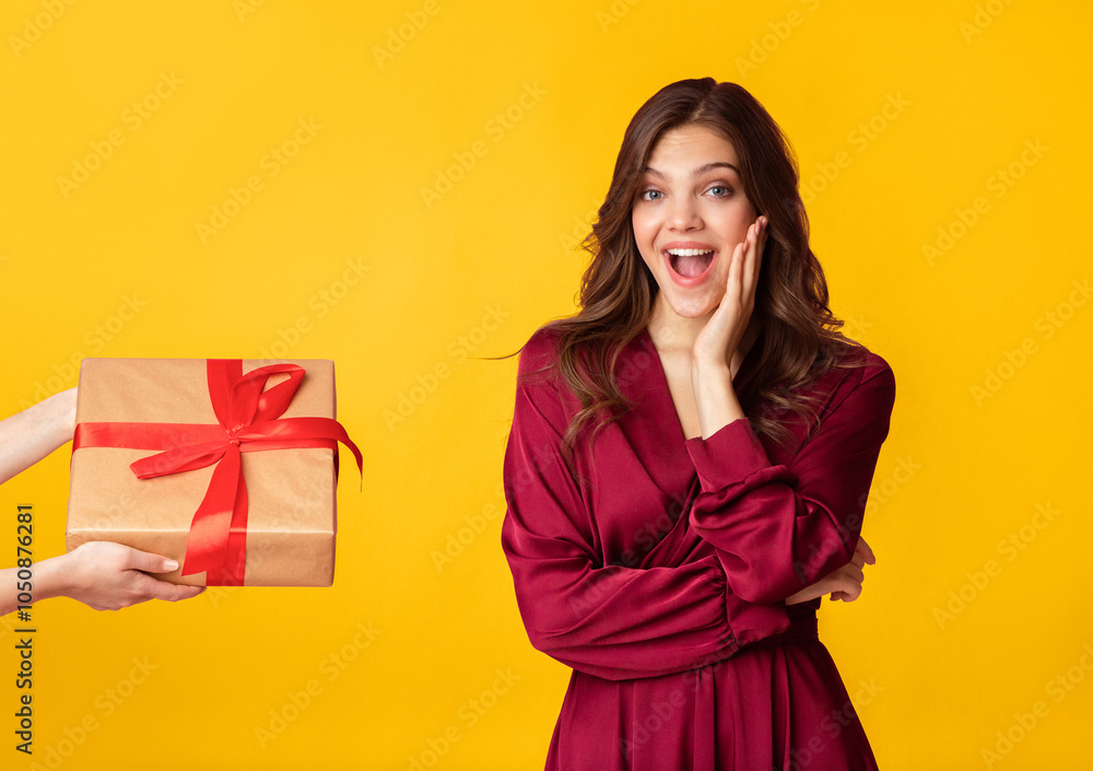 Bonus Surprise. Unrecognizable Person's Hand Giving Gift Box To Excited Woman, Colorful Studio Background With Free Space Bonus Surprise. Unrecognizable Person's Hand Giving Gift Box To Excited Woman, Colorful Studio Background With Free Space