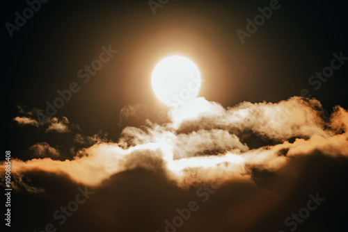 Bright sun illuminating fluffy clouds at dusk over a serene landscape, creating a warm golden glow in the sky