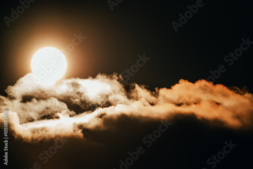 Bright sun illuminating fluffy clouds at dusk over a serene landscape, creating a warm golden glow in the sky