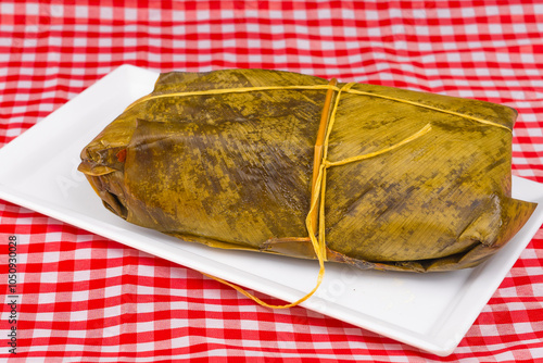 Colombian tamale recipe with steamed banana leaves photo