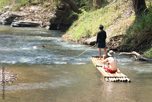 Bamboo rafting in green tropical scenery as a tour for tourist in Mae Wang District Chiang Mai Thailand. photo