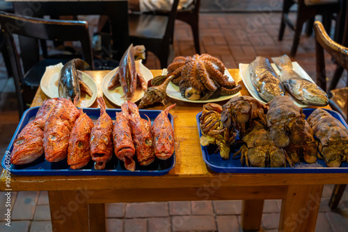 Fresh locally-caught seafood on display outside of restaurant in Puerto Ayora. Includes brujo (scorpion fish), octopus, and slipper lobster