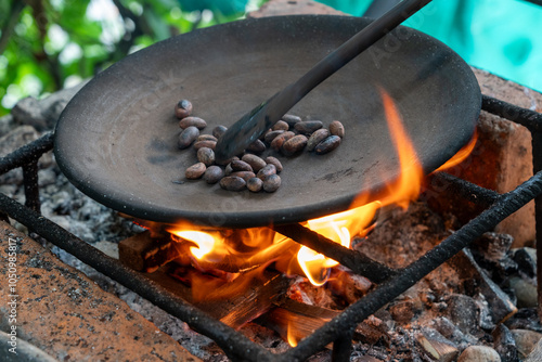 Photography Cacao beans roasting over a fire on a primitive grill