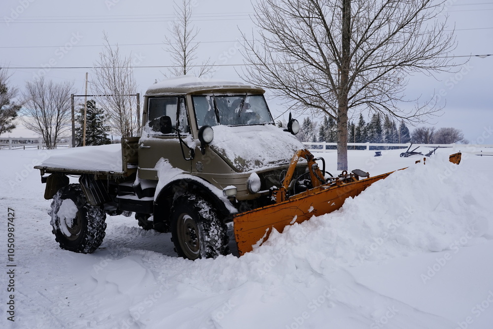 unimog snow plow removing snow from a driveway after a blizzard in Cheyenne wyoming unimog snow plow removing snow from a driveway after a blizzard in Cheyenne wyoming