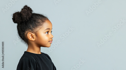 Afro little girl in traditional kaftan cloth made from luxury fabric photo