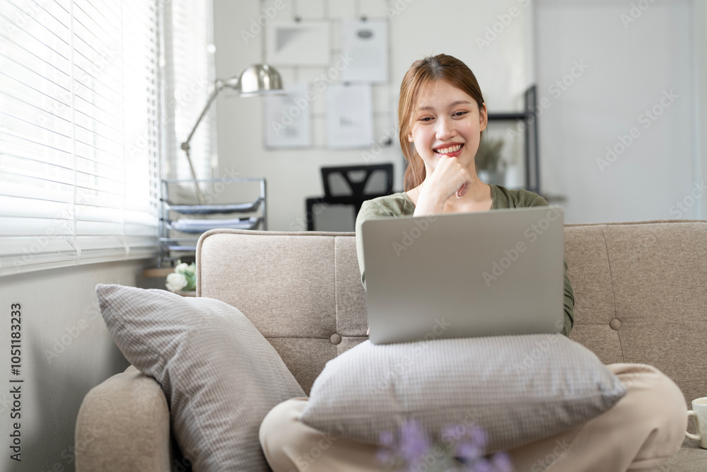 Concentrated girl sit on couch working on laptop browsing internet at home during lazy weekend Concentrated girl sit on couch working on laptop browsing internet at home during lazy weekend