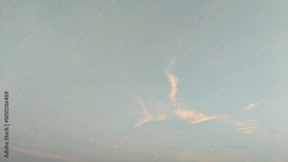 A pale blue sky with wispy white clouds forming an interesting pattern. The clouds appear to be moving across the sky. A pale blue sky with wispy white clouds forming an interesting pattern. The clouds appear to be moving across the sky.