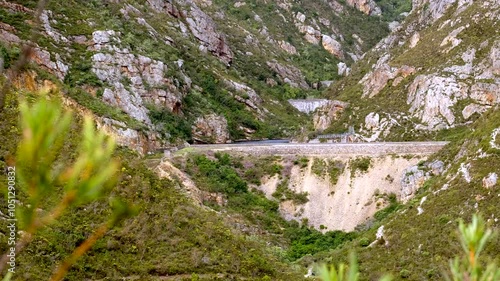 Telephoto pan shot reveals three dams hiking trail in Hermanus, reservoirs in mountain valley for water storage photo