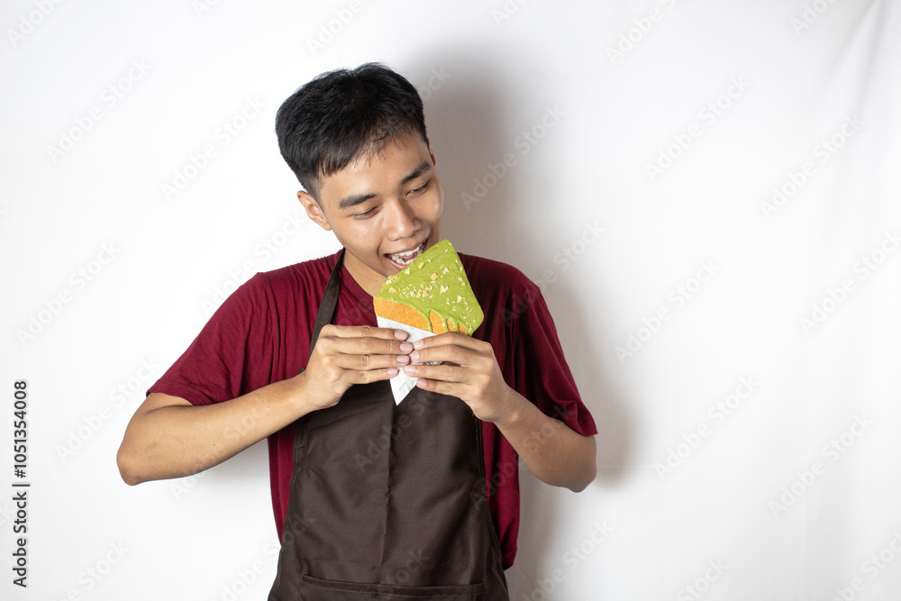 teenage bartender biting a snack in his hand teenage bartender biting a snack in his hand