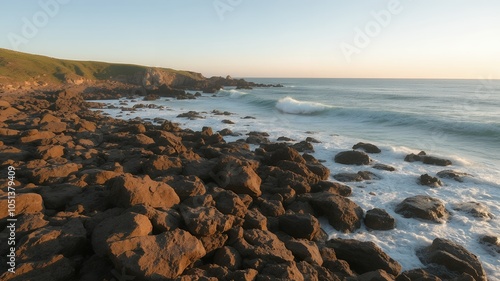 Rocky shoreline with foamy waves crashing on the coast.