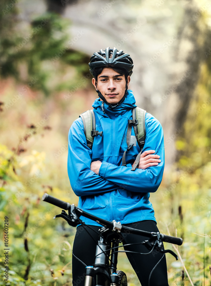 Portrait of cyclist in the middle of forest during early autumn morning. Concept of healthy lifestyle. Portrait of cyclist in the middle of forest during early autumn morning. Concept of healthy lifestyle.