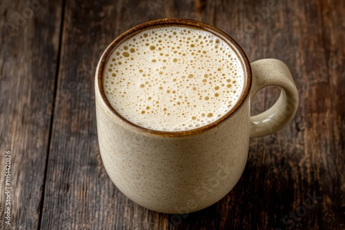 Freshly poured frothy pasteurized milk topped with a thick, creamy foam, perfect for coffee or breakfast. photo