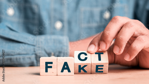 Obraz na plátne Flipping Wooden cube block for change fake to fact , news and social media concept