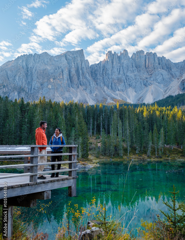 Enjoying tranquil moments by the emerald lake in the stunning Dolomites of Italy Enjoying tranquil moments by the emerald lake in the stunning Dolomites of Italy