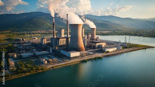 An industrial facility using cooling towers, where waste heat is released into the atmosphere and nearby water bodies, contributing to thermal pollution photo