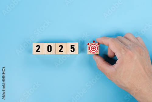 Happy new year 2025 with start new business goal. 2025 business goals. Wooden block with 2025 word and target icon. photo