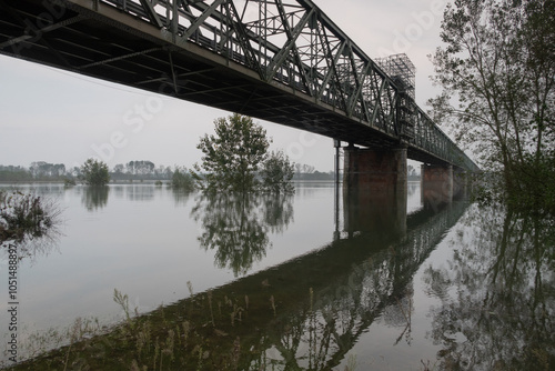 Obraz na płótnie GPS INSIDE Flood River Po Ticino Bridge Becca water banks trees boats harbor panorama nature landscape w salonie