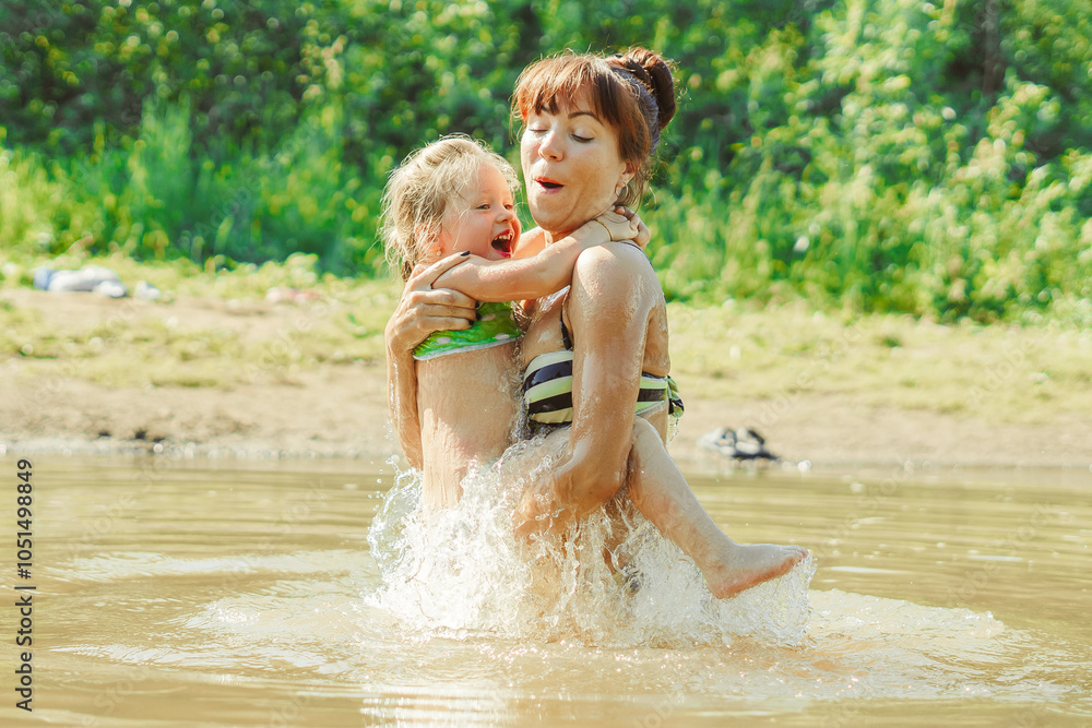 mom and child swim in the river mom and child swim in the river