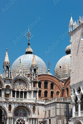 Wallpaper Mural A masterpiece of Venetian architecture shines under the blue sky. St. Mark's Basilica showcases its elaborate façade with intricate arches, statues, and iconic Byzantine domes, blending mosaic and mar Torontodigital.ca