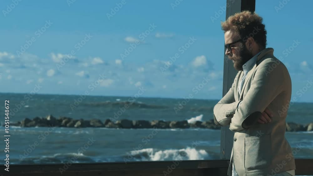 A man stands by the sea, close to tears, overwhelmed by family issues. The emotional weight of his problems is evident in his somber expression and posture. A man stands by the sea, close to tears, overwhelmed by family issues. The emotional weight of his problems is evident in his somber expression and posture.