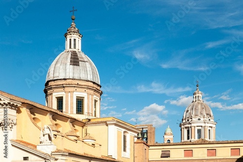 Classic domes under a clear blue sky in Rome.