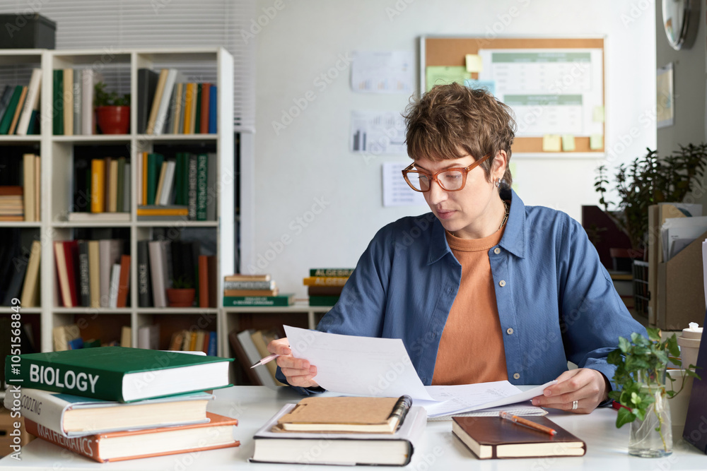 Person analyzing documents and notes in a well-organized library filled with books and plants. Engaging in a detailed study session while seated at a desk Person analyzing documents and notes in a well-organized library filled with books and plants. Engaging in a detailed study session while seated at a desk