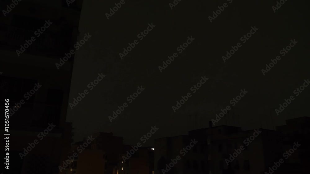 A fierce lightning storm lights up the buildings, creating dramatic ...