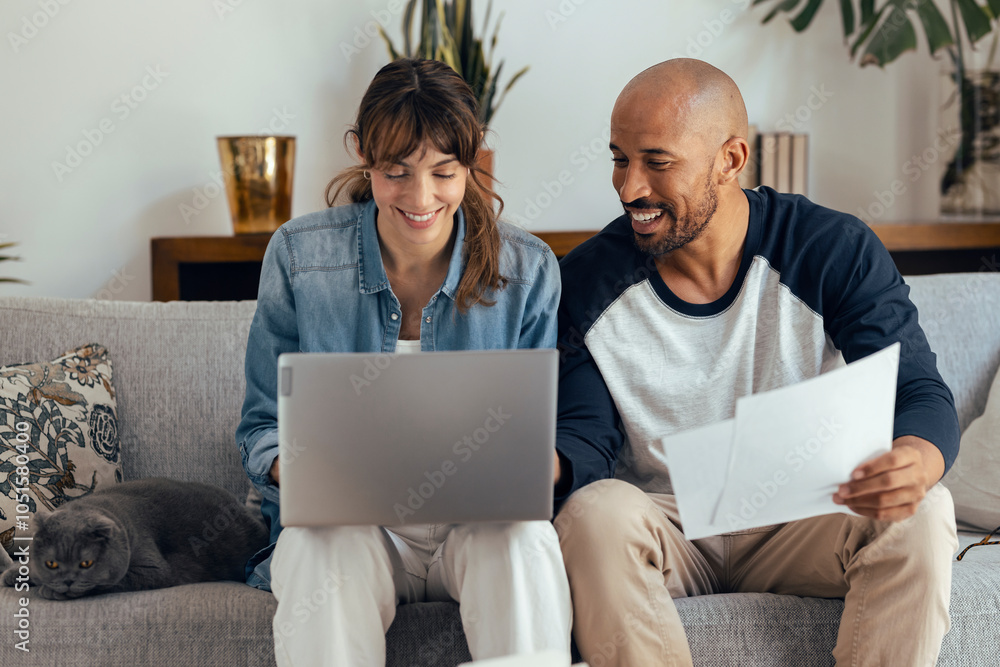 Happy man preparing financial bill with girlfriend using laptop at home Happy man preparing financial bill with girlfriend using laptop at home