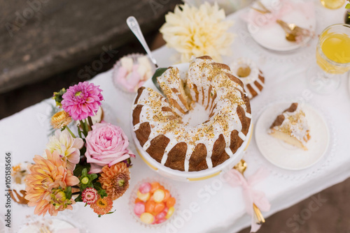 Cake on decorated table at garden party photo