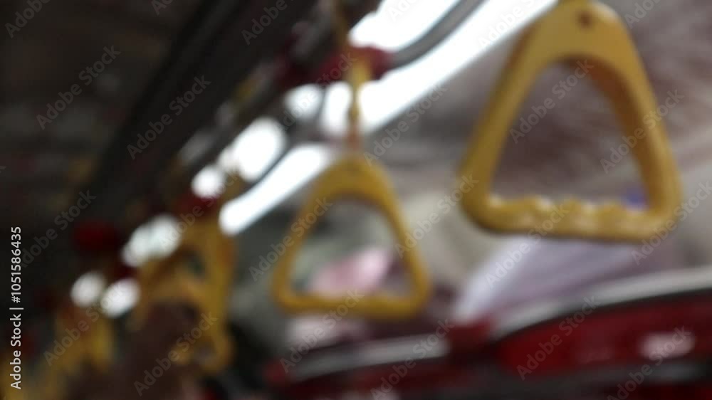 close up of passenger's hand grip inside the train, commuter line, indonesian railways company close up of passenger's hand grip inside the train, commuter line, indonesian railways company