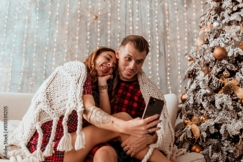 young couple in love taking selfie at home and having fun, Christmas concept, holidays