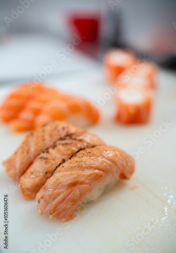 Fresh salmon sushi close-up on cutting board.