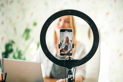 coach or influencer recording content with professional light and phone, creating a personal connection with viewers on blog