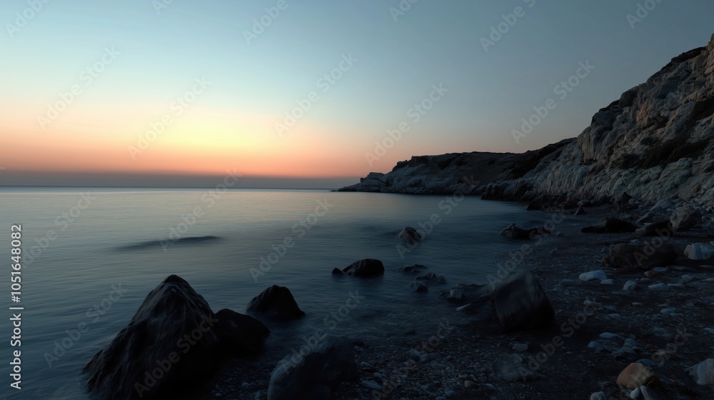 Serene coastal sunset over calm waters, rocky shoreline, soft colors