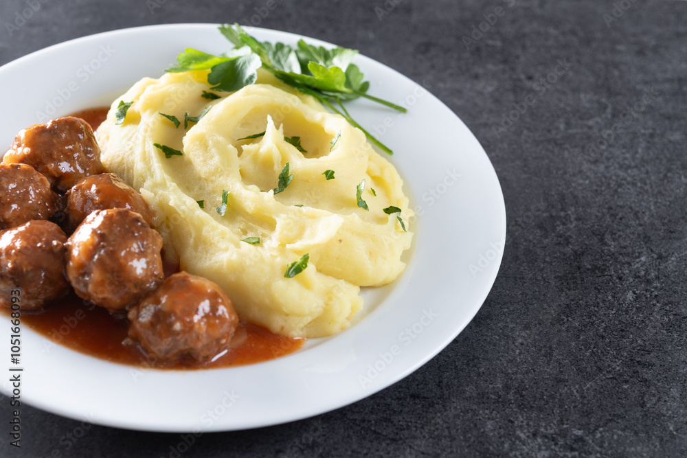 Meatballs with mashed potatoes on black slate background. Copy space Meatballs with mashed potatoes on black slate background. Copy space