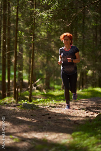 Woman running on a trail in the mountains