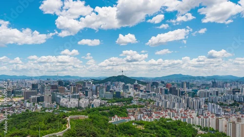 4K time lapse of Seoul's downtown cityscape beautifully cloudy day. Bright blue sky contrasts with the city's vibrant atmosphere, perfectly capturing the dynamic energy of the capital of South Korea