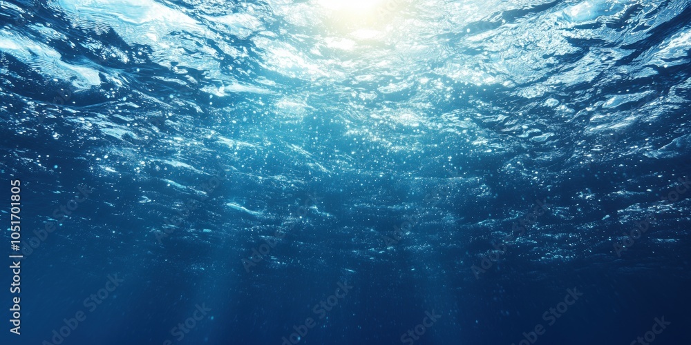 Underwater scene with sunlight, shimmering water surface, and bubbles Underwater scene with sunlight, shimmering water surface, and bubbles