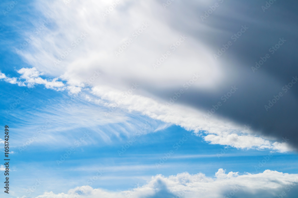 Fototapeta premium Blue sky landscape with dramatic clouds lit by evening sunlight