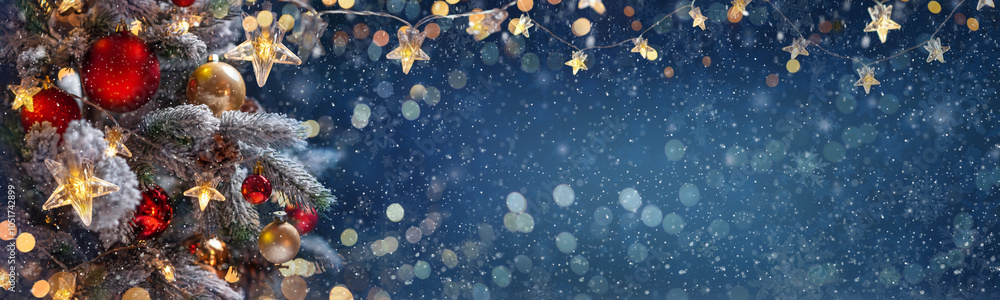 Christmas tree with Christmas balls on the background of the night sky - decorations on fir branches with shiny and unfocused lights and snowflakes on an abstract background
