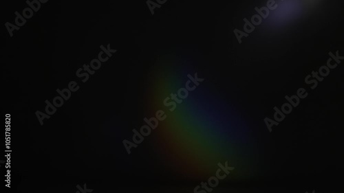 Rainbow highlights on a black background. Unfocused shining multicolored rainbow light. photo