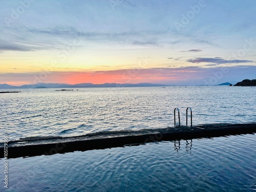 Coastal sunset view from Aegina town across Saronic Gulf to the Greek mainland, Aegina, Greece photo