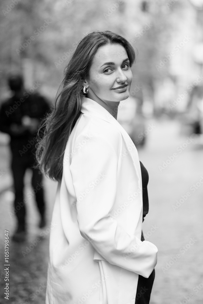 Elegant Woman in White Blazer on City Street Elegant Woman in White Blazer on City Street