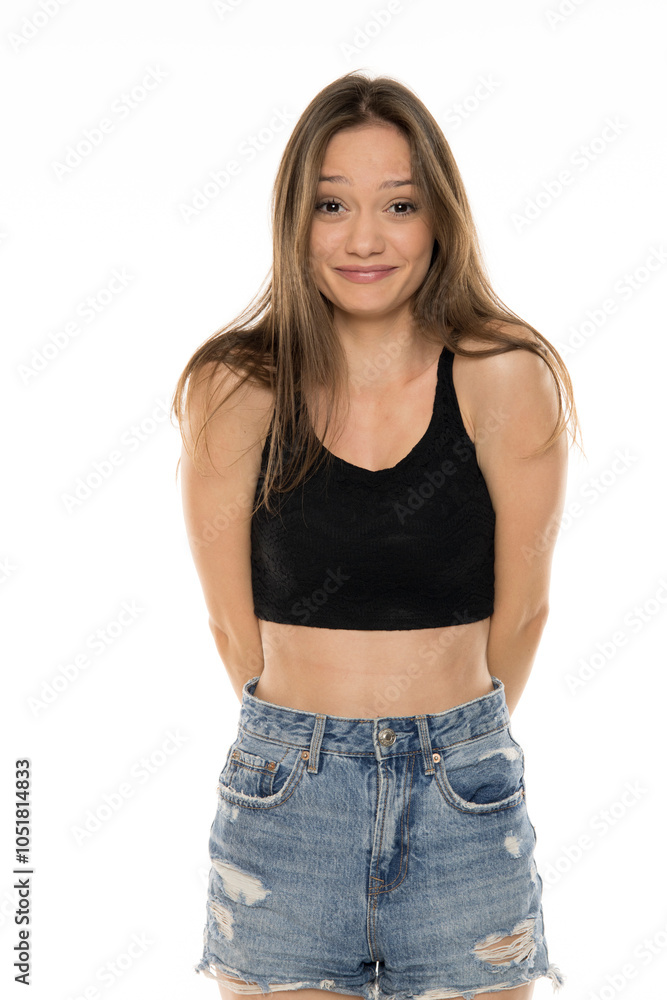 Embarrassed girl laughing and looking at you. Pretty young woman with brown hair smiling Embarrassed girl laughing and looking at you. Pretty young woman with brown hair smiling